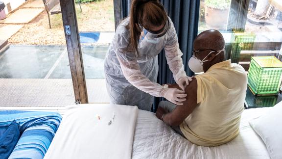 A patient in a care home receiving a COVID-19 vaccination.