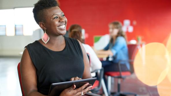 An office worker holding a tablet.