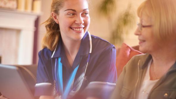 A nurse with a patient, on a home visit.