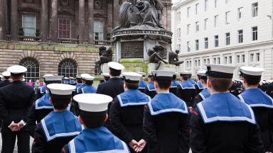 A group of navy officers at a parade.