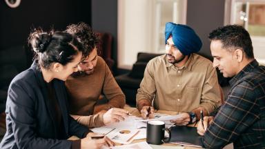 A diverse team meeting around a table.