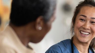 A doctor smiling at a patient.