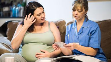 A midwife with a patient on a home visit.