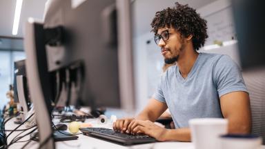 An officer worker, typing.