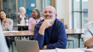 Man in webinar, thinking