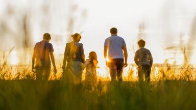 Family walking in field