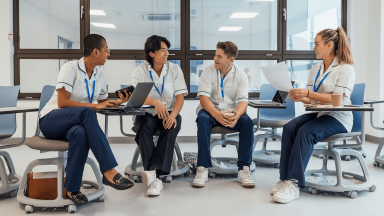 four nurses talking