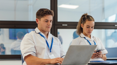 Two nurses on their screens
