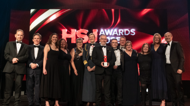 The team from ESHT receive their HSJ award from Rob Brydon