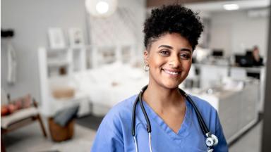 A BME nurse on a hospital ward smiling