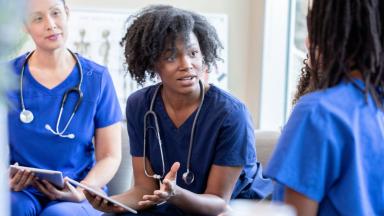 Three diverse nurses having a discussion