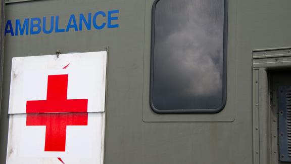A close up of a red cross on a military ambulance.