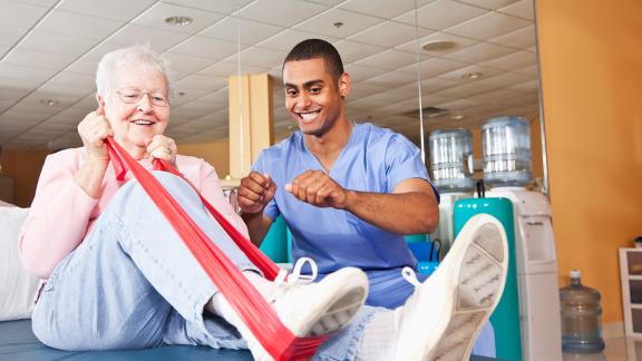A physiotherapy patient using a stretch band on their leg.