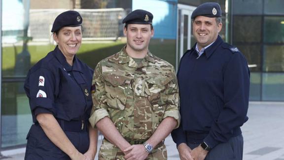 Three reservists standing casually outside representing the United Kingdoms Navy, Army and Royal Air Force Reservists.