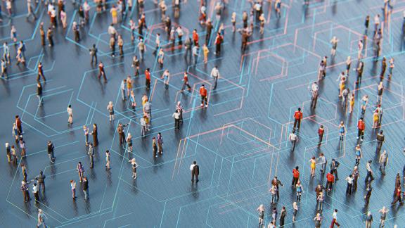 Model figures of people standing around with a matrix of lines connecting them.