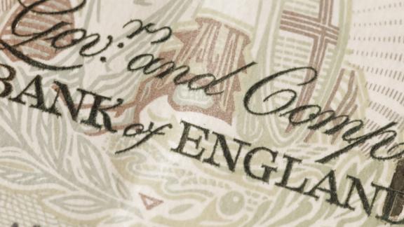 A sepia-toned close-up image of a banknote