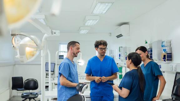 A diverse group of medical colleagues having a conversation on a ward.