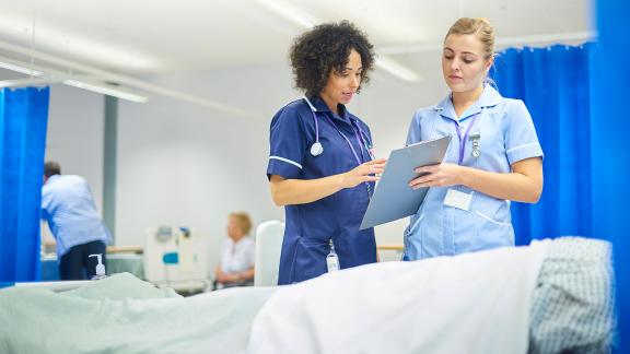 A couple of medical students learning on a ward.