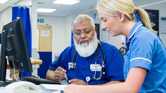 A doctor and nurse examining papers