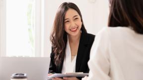 An interviewer holding a file.