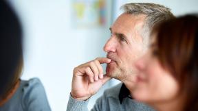 An officer worker listening in a meeting.