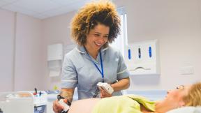 A midwife checking their patient during a hospital appointment.