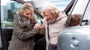 Carer helping out of car