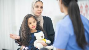 A patient and her child attending a medical appointment.