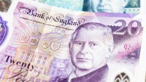 Five pound note and twenty pound note fanned with King Charles' head displaying and 'Bank of England'