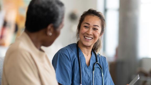 A doctor and patient, smiling.