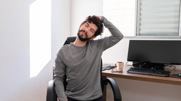 A home worker stretching their neck.