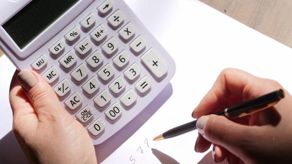 A hand holding a calculator