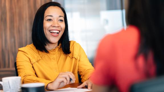 An office one to one meeting across a table.