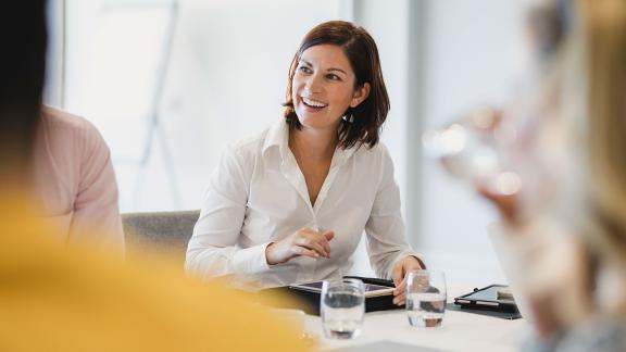 An office worker using a tablet during a meeting.