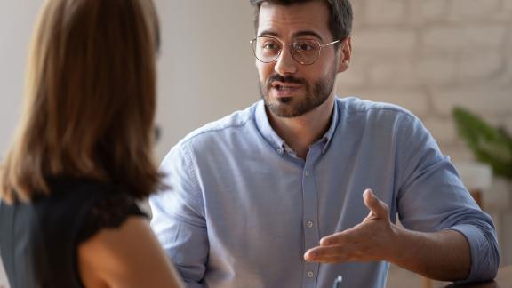 A pair of office workers talking.