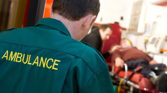 A paramedic entering an ambulance.