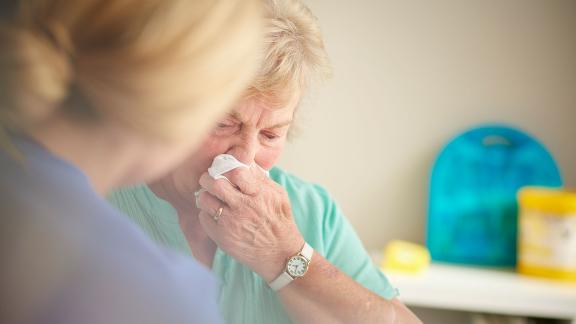 A patient at an appointment, crying.