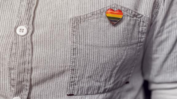 A heart-shaped pride bag attached to a shirt pocket.