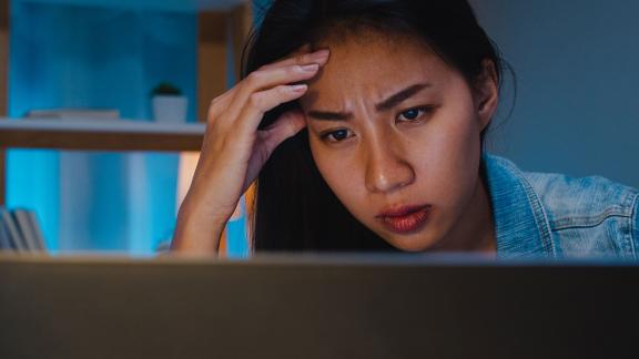 An office worker concentrating at what's on their screen.