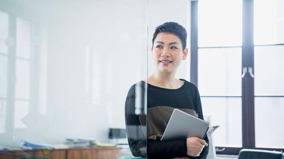 An office worker holding a tablet.