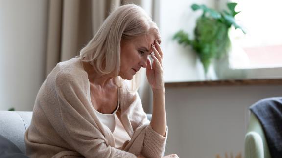 A woman resting her head on her hands.