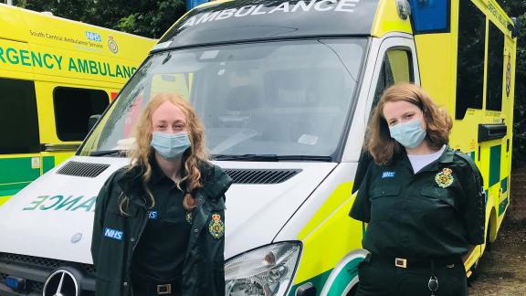 Two members of the SCAS team standing in front of an ambulance.