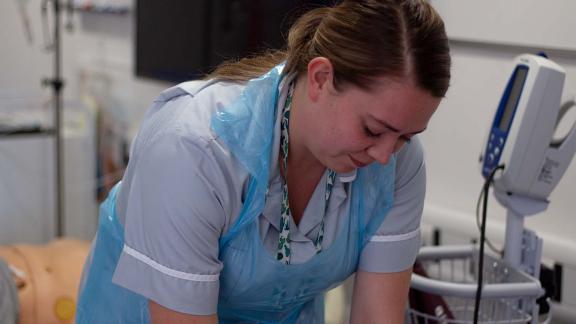 Young healthcare worker practising a task