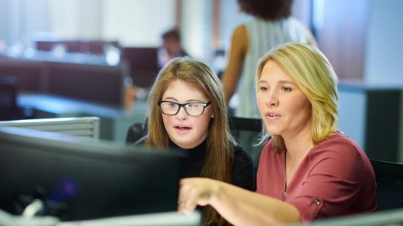 Image of two ladies looking at a computer