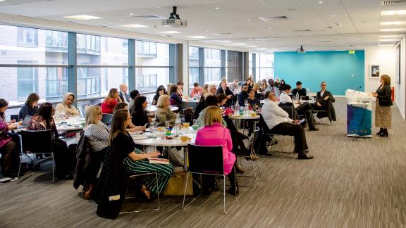 People in a conference room listening
