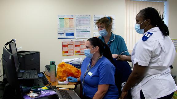 Group of staff at a computer