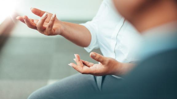 A close up of a person's hands, while explaining something.