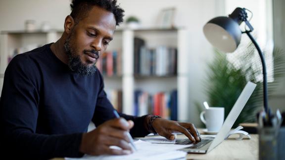 A homeworker making notes.
