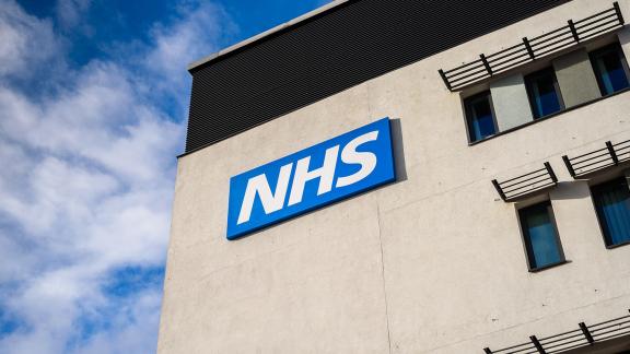 The NHS logo on a hospital building