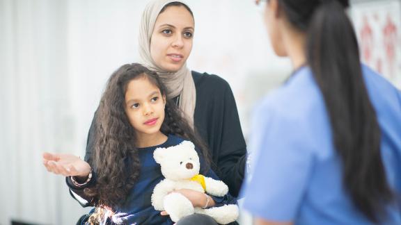 A patient and her child attending a medical appointment.
